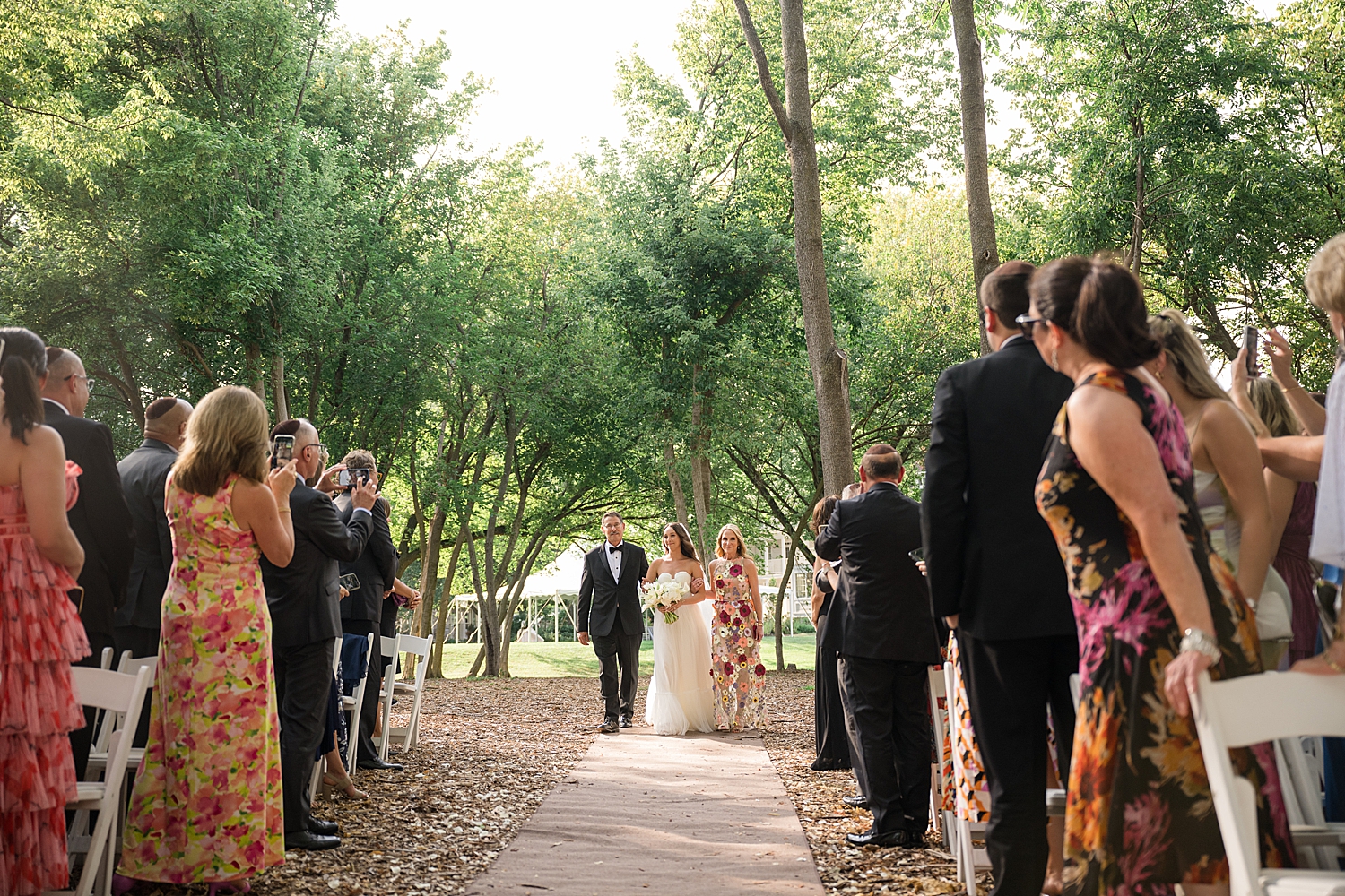 bride escorted down aisle with her parents