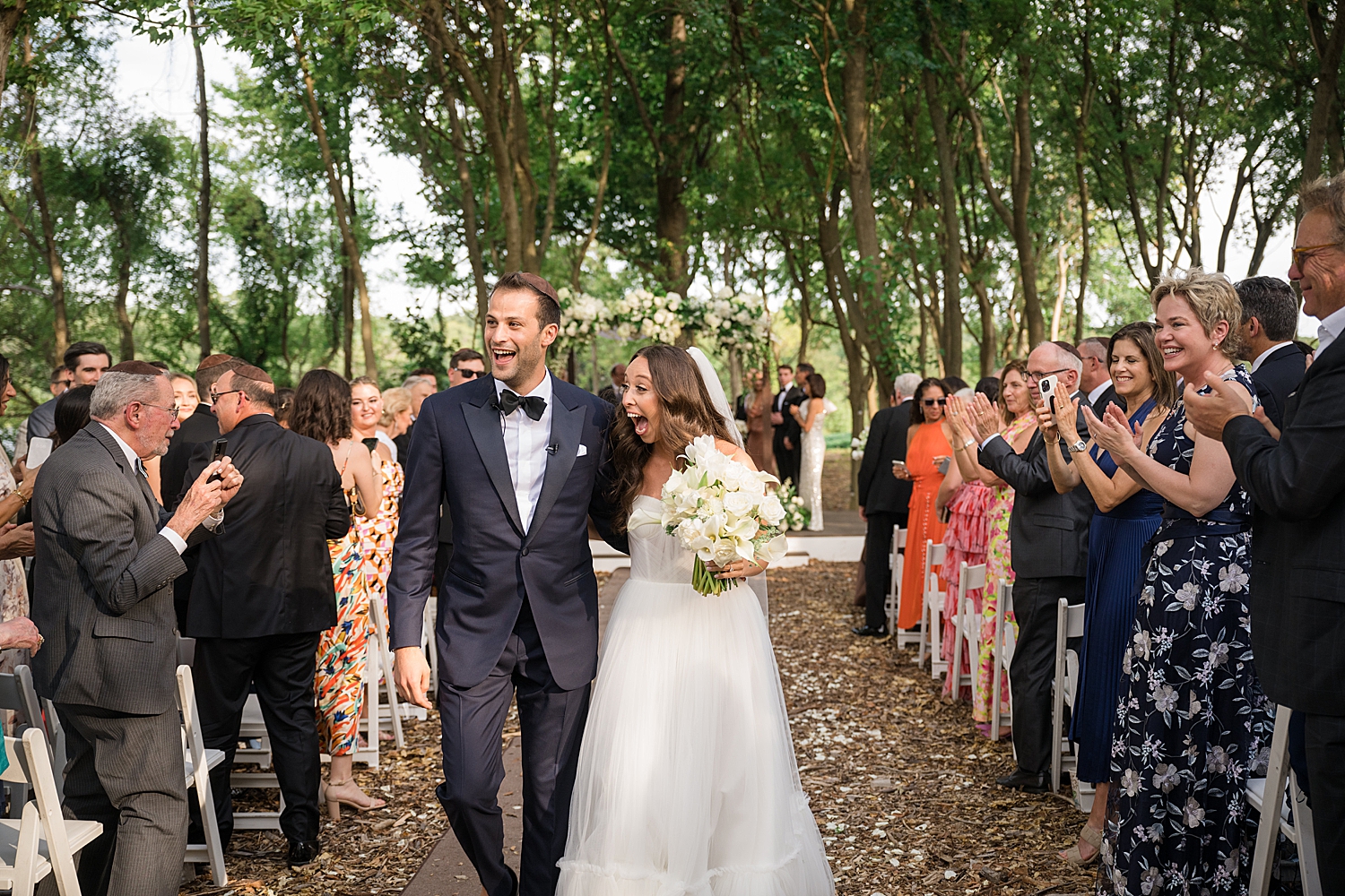 bride and groom celebrate as they recess from ceremony