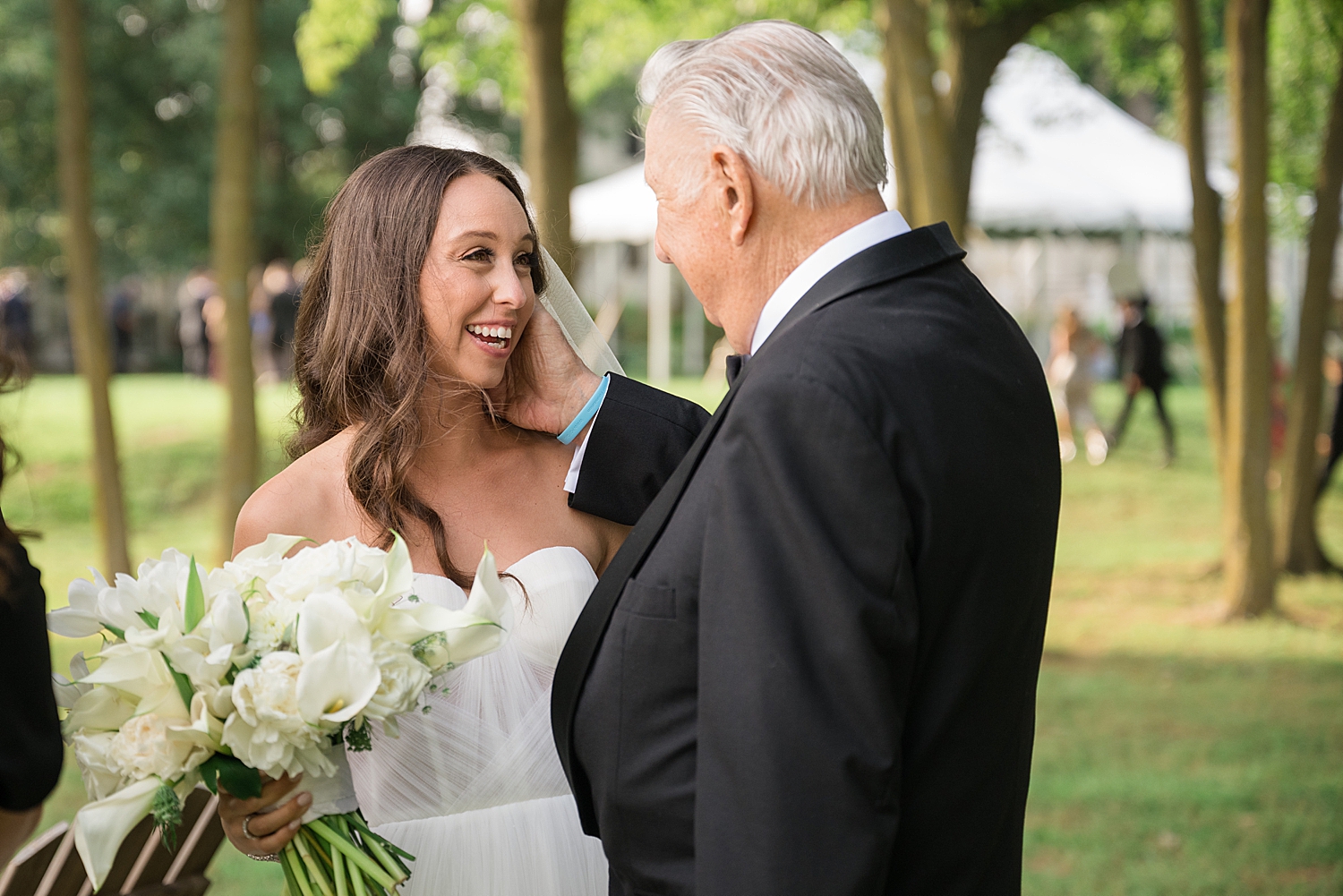 bride smiles with grandfather on wedding day