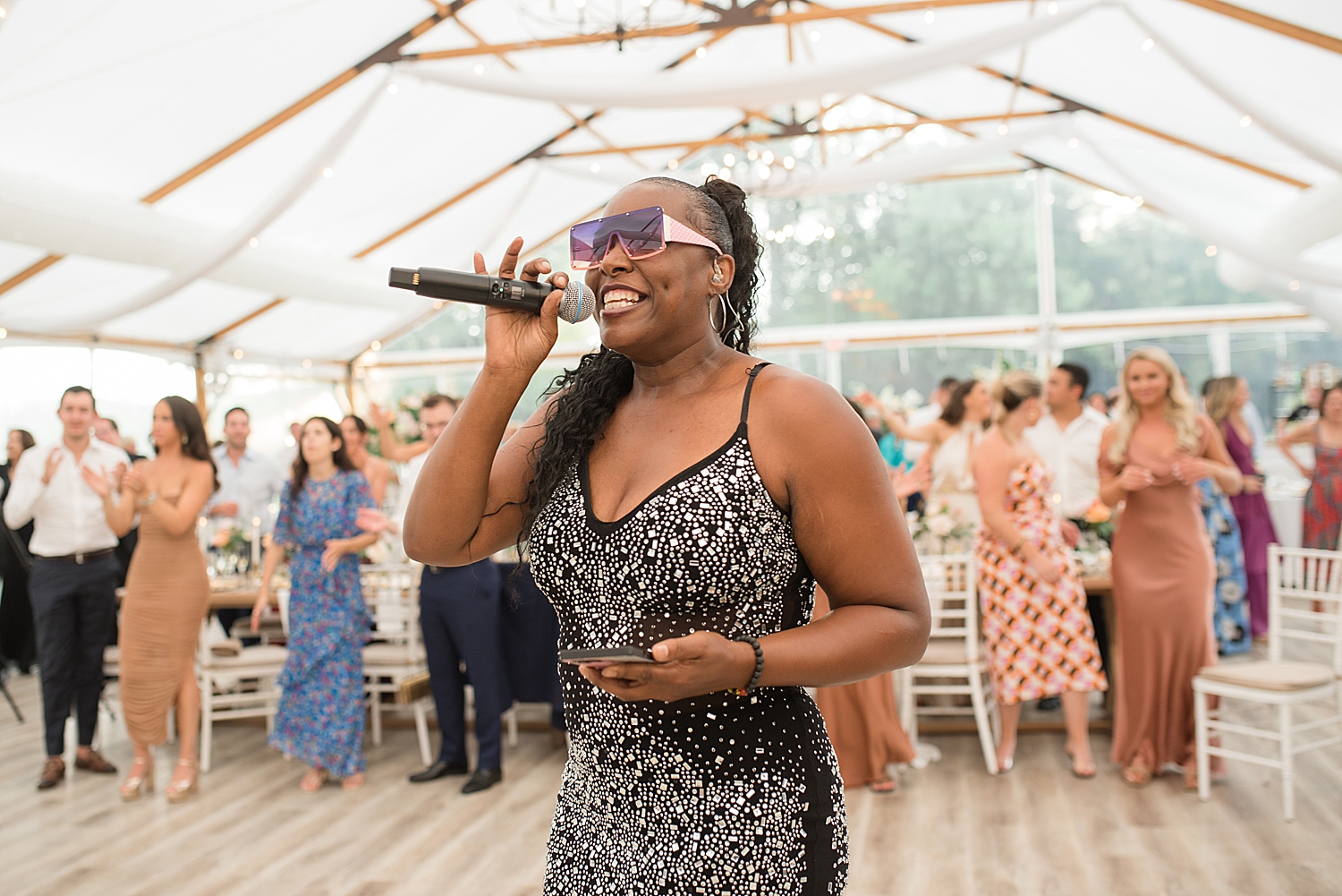 performer talks on microphone to start reception