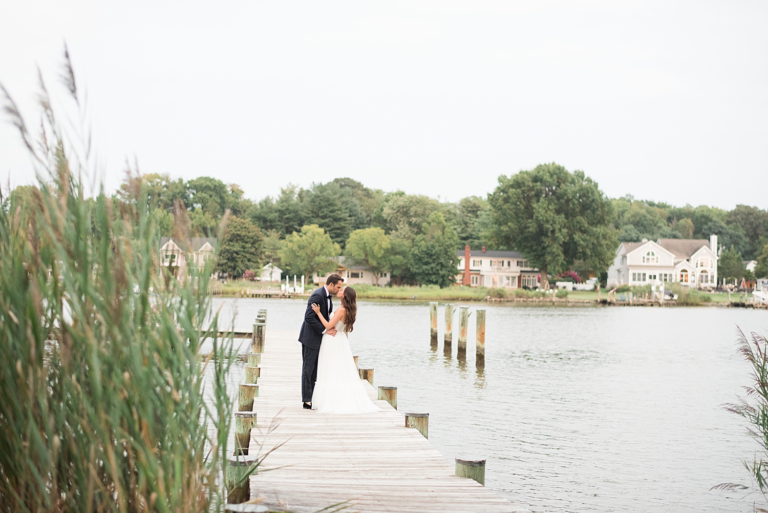 bride and groom portrait on pier