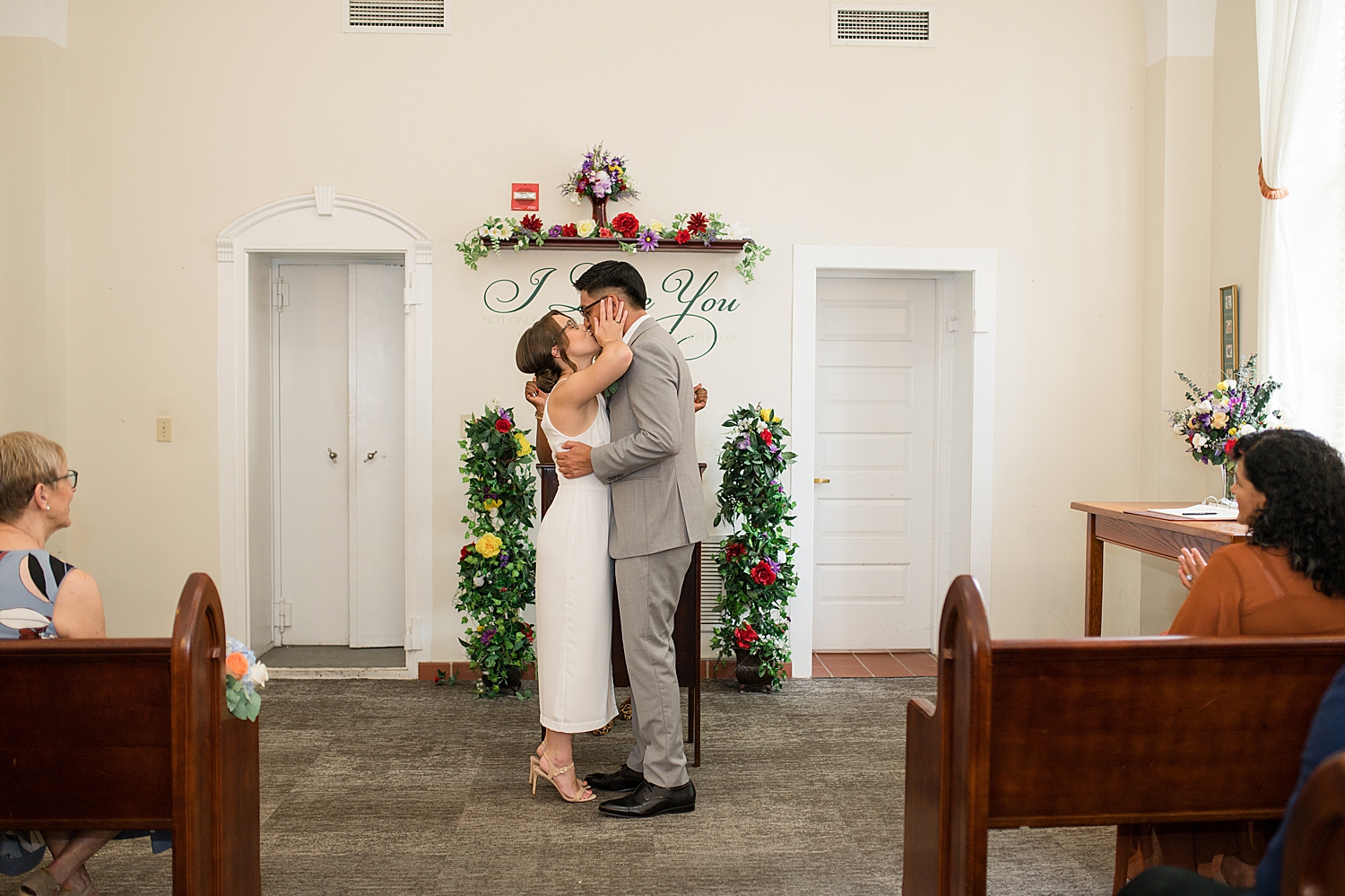 bride and groom first kiss courthouse