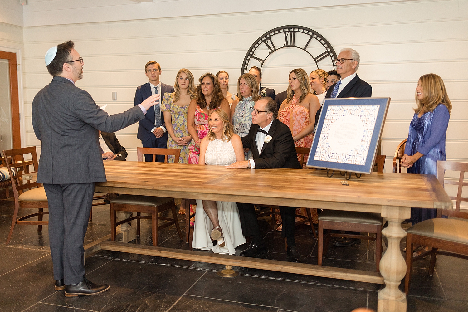 bride and groom sign ketubah