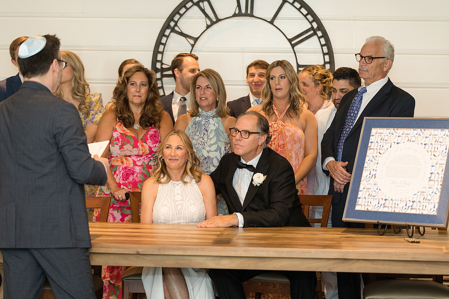 bride and groom sign ketubah