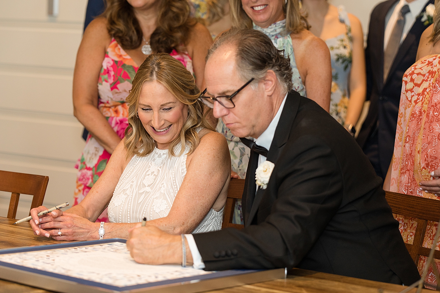 bride and groom sign ketubah