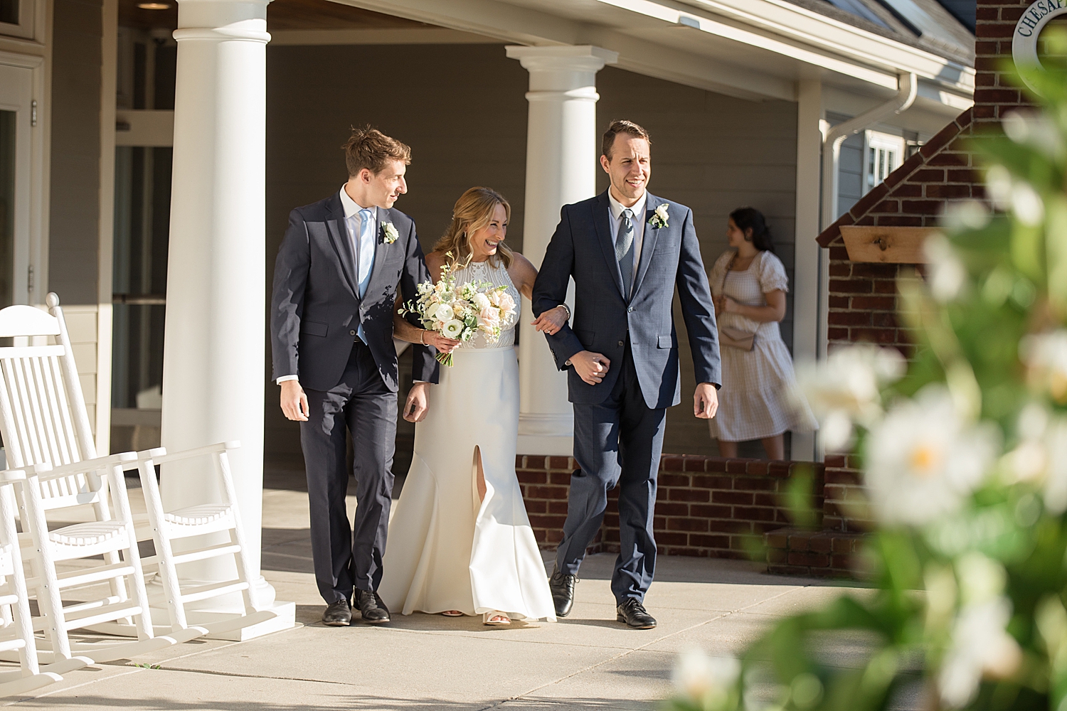 bride enters ceremony, escorted by sons