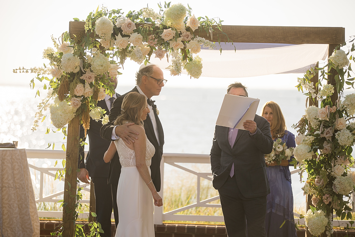 rabbi reads horah with bride and groom