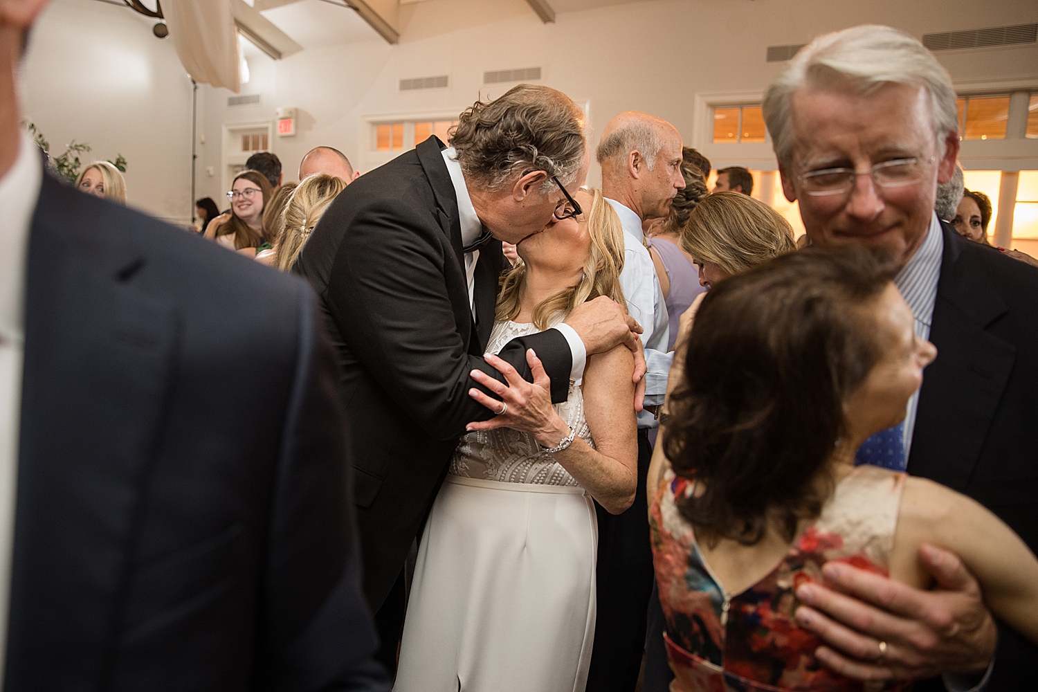 bride and groom kiss on dance floor