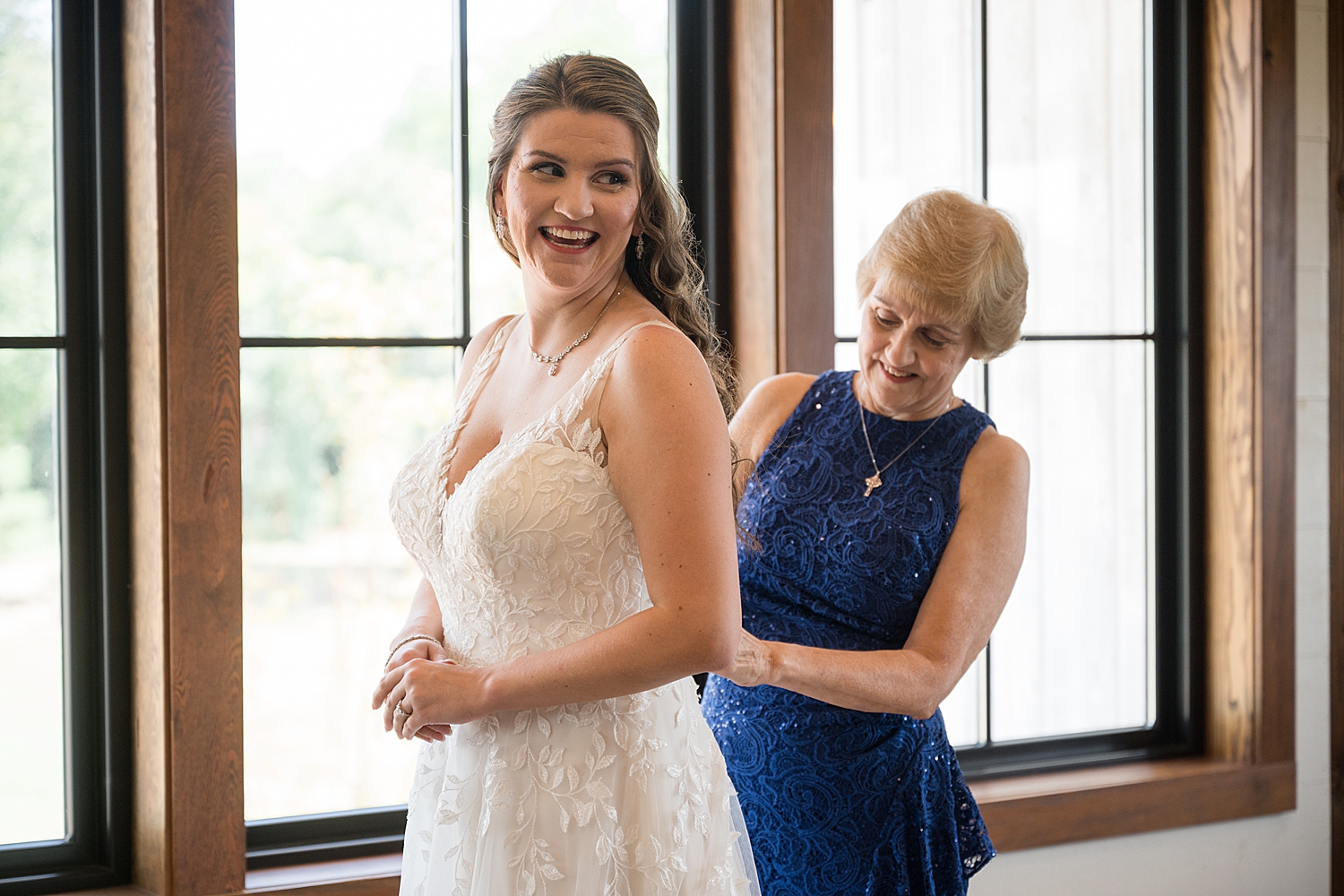 bride's mom helps her get ready