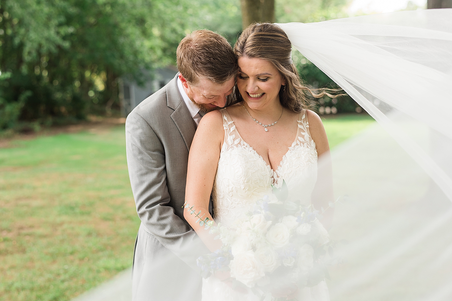 groom kisses bride's shoulder