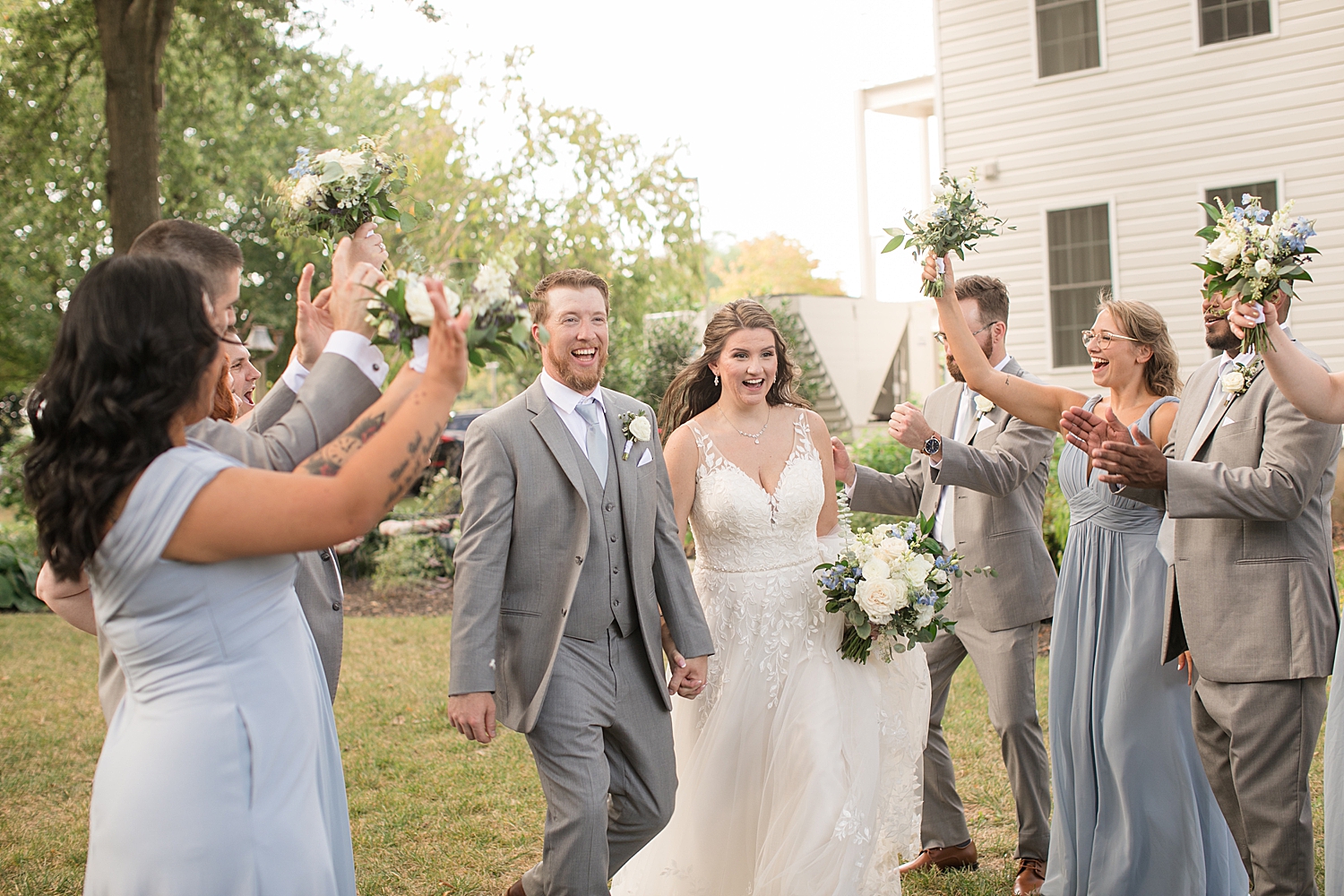 bride and groom celebrate with wedding party