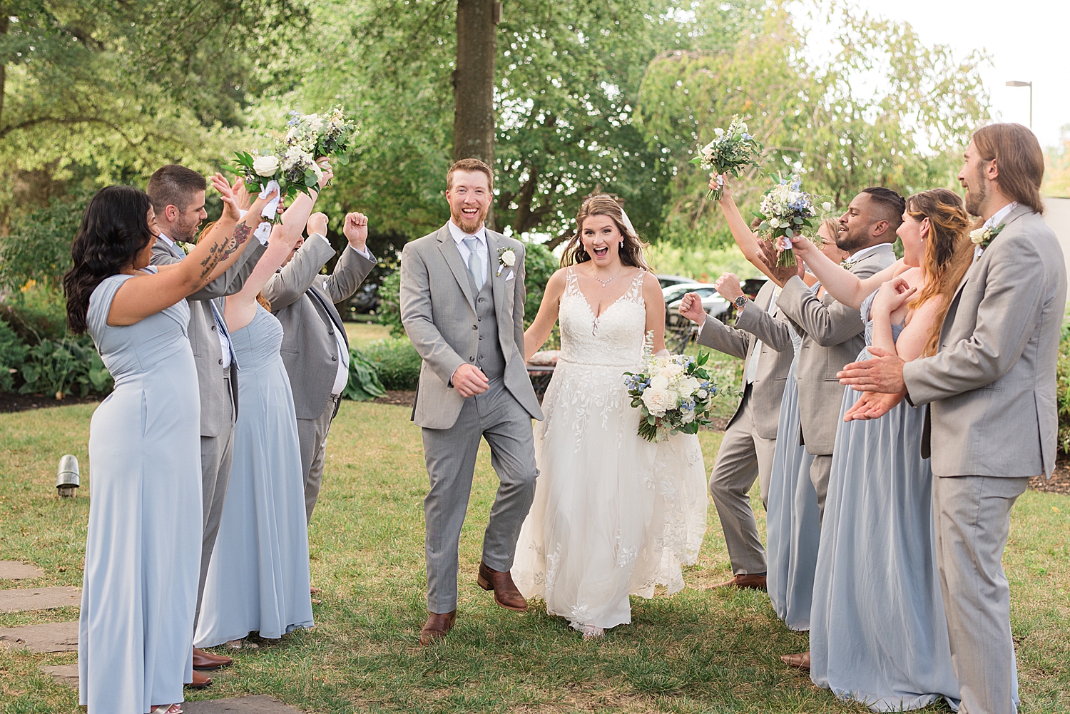 bride and groom celebrate with wedding party