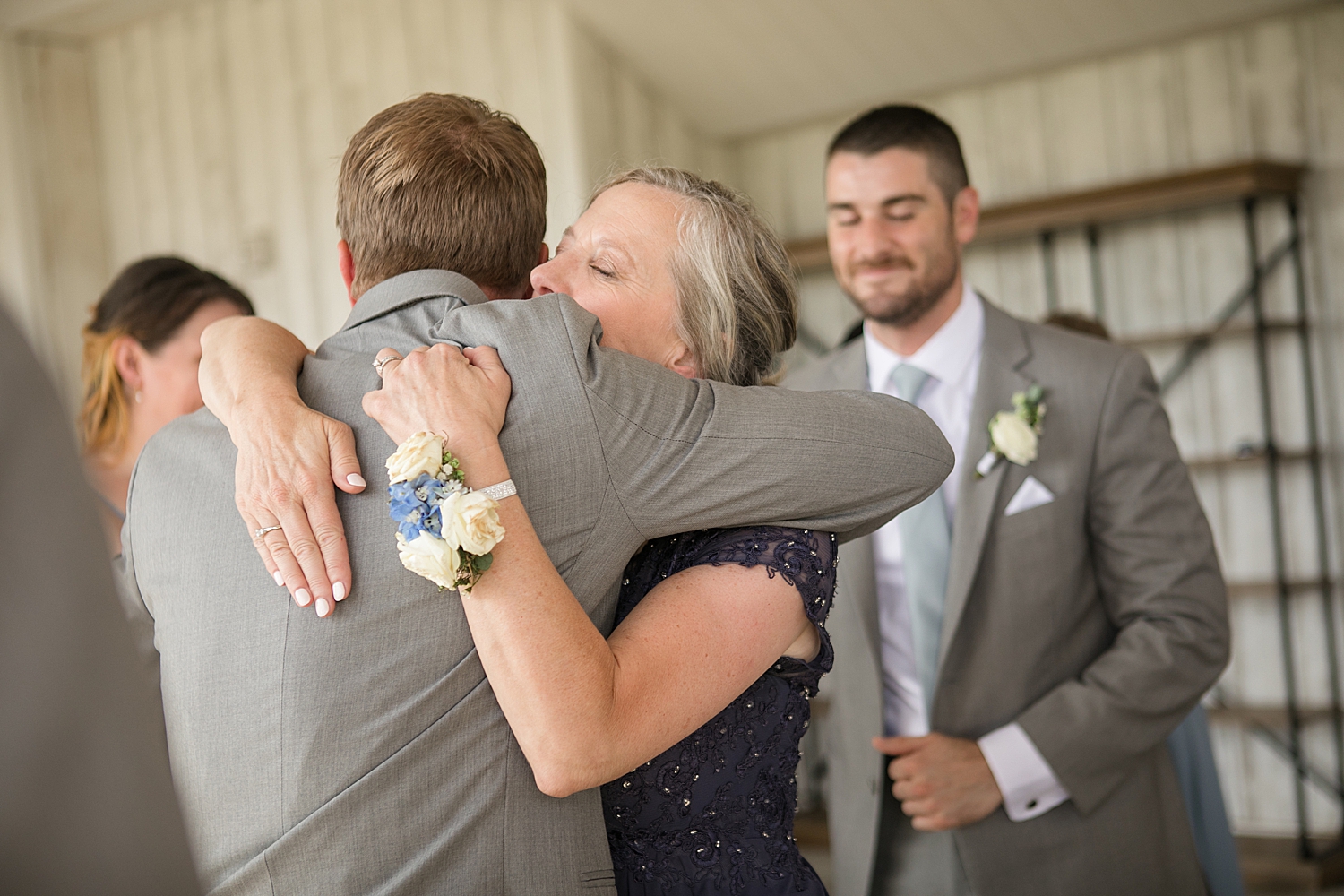 groom shares hug with mom after ceremony