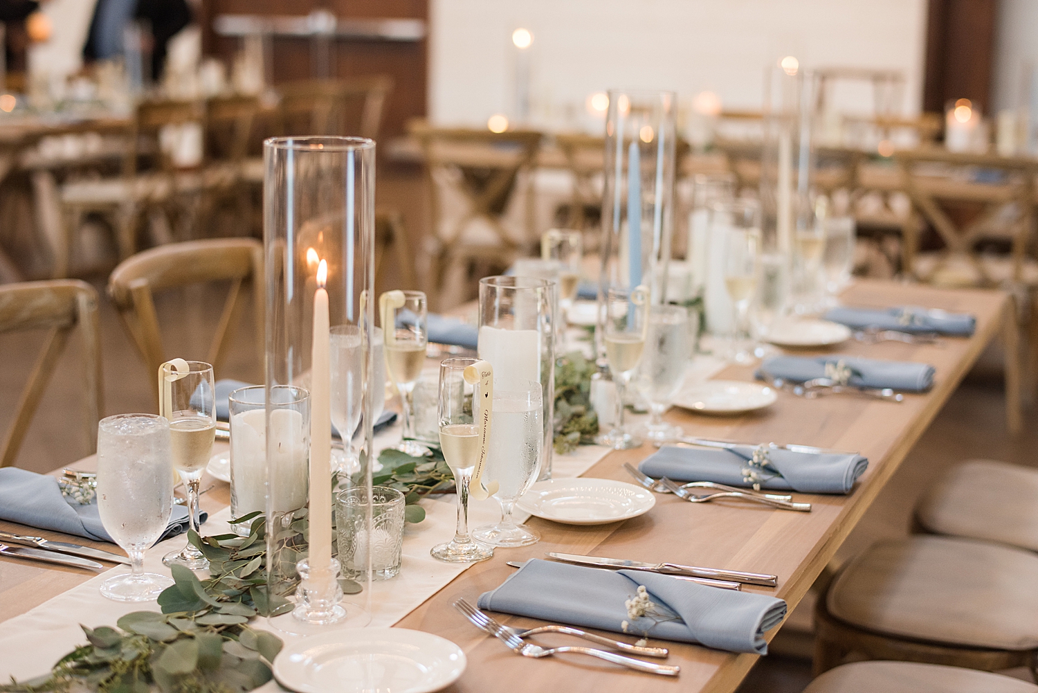 reception tablescape with farmhouse tables and blue linens