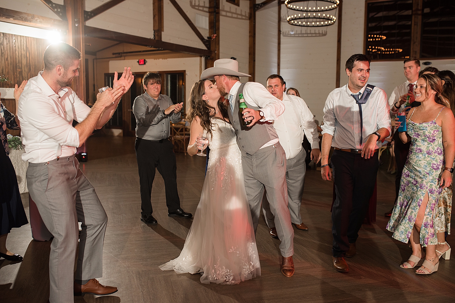 bride and groom kiss on dance floor