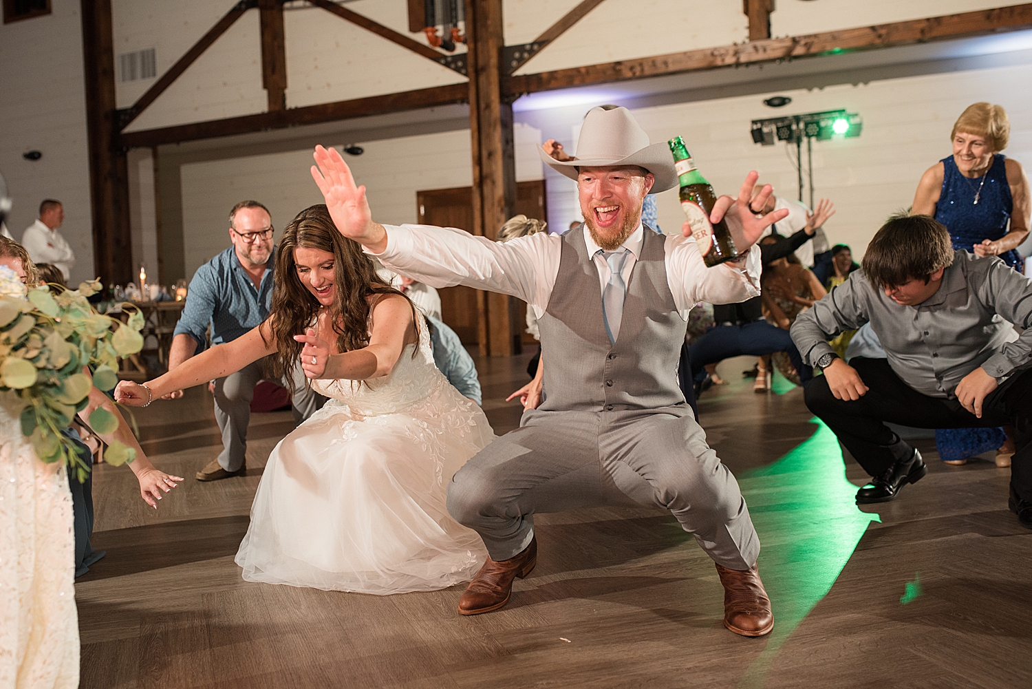 candid wedding guests dancing bride and groom get low