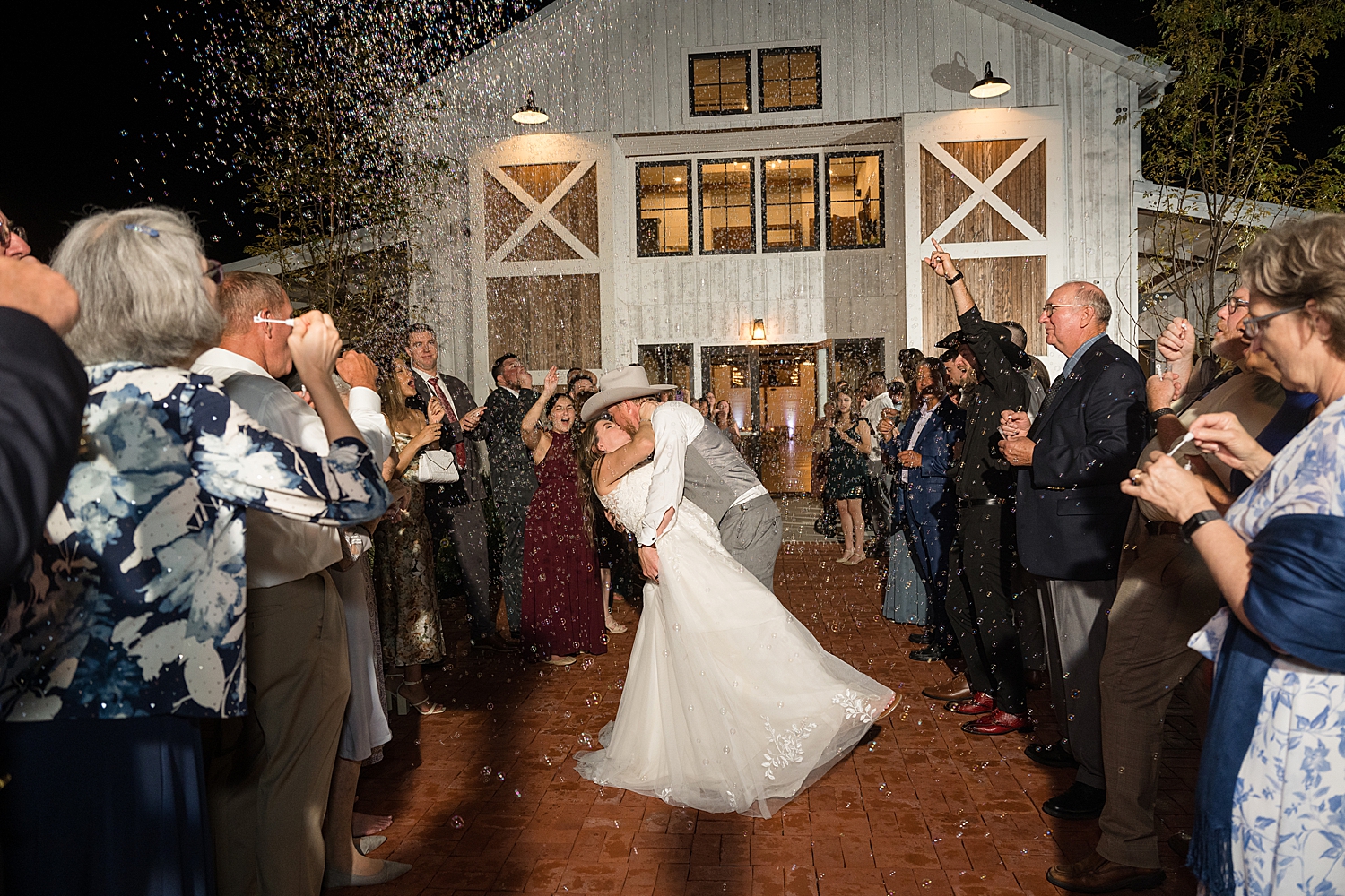 bride and groom bubble exit dip kiss