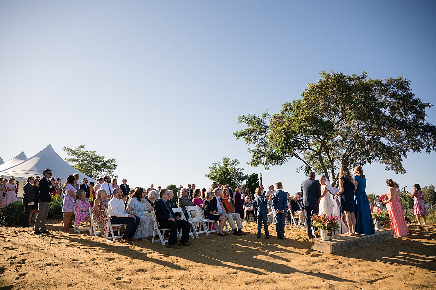 wide shot of ceremony on the beach