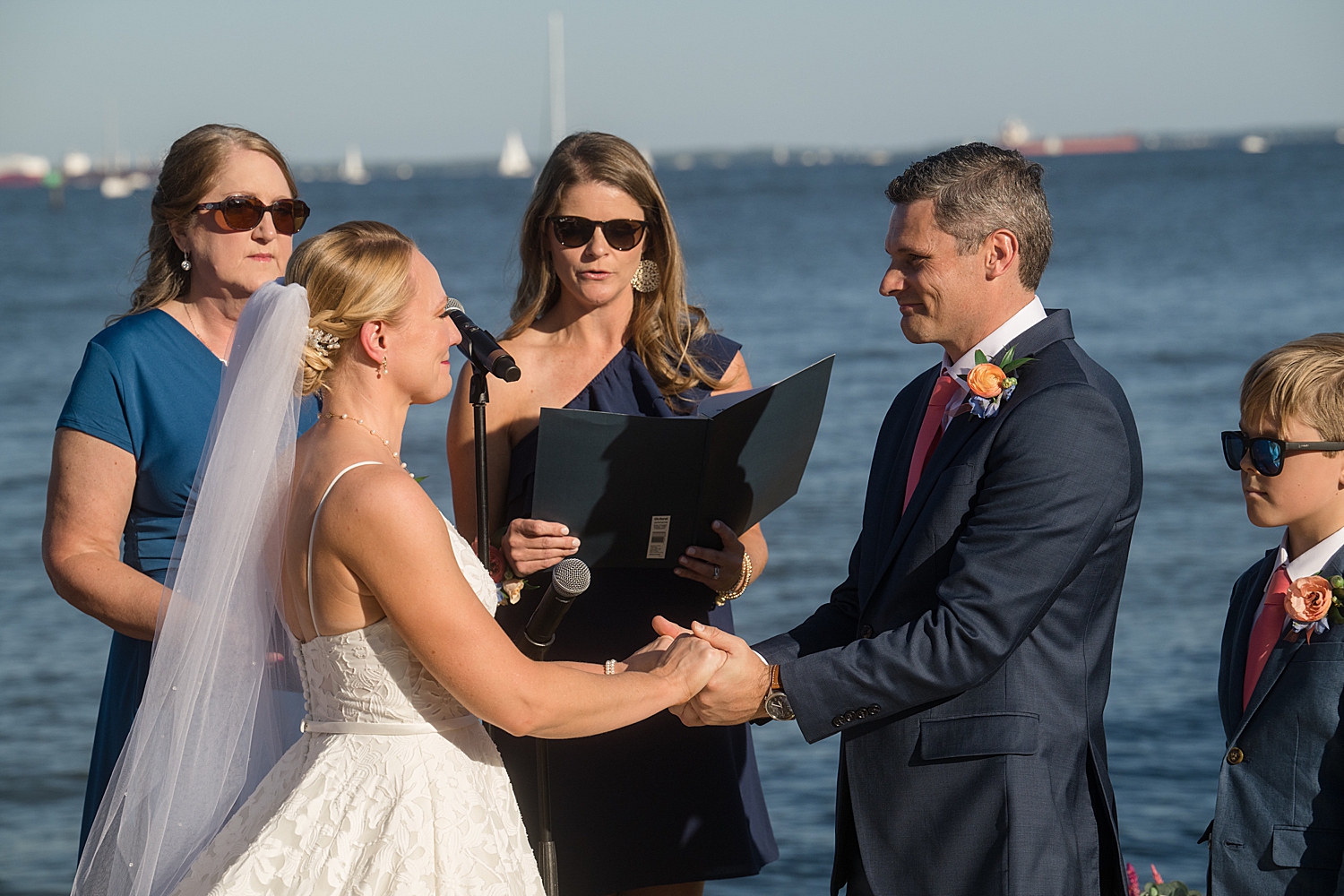 bride and groom hold hands during ceremony