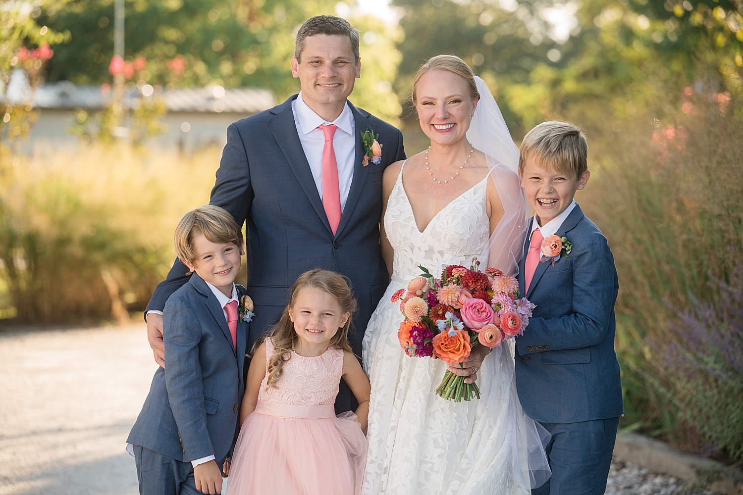 family portrait of bride and groom with kids