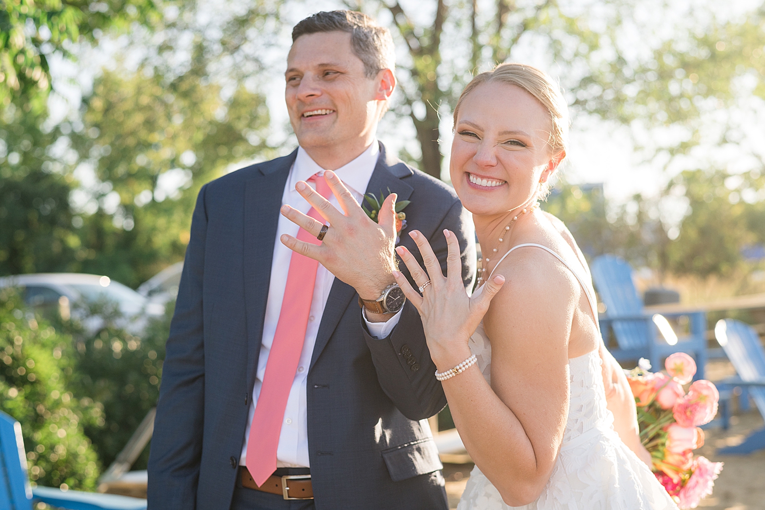 bride and groom show off their new rings