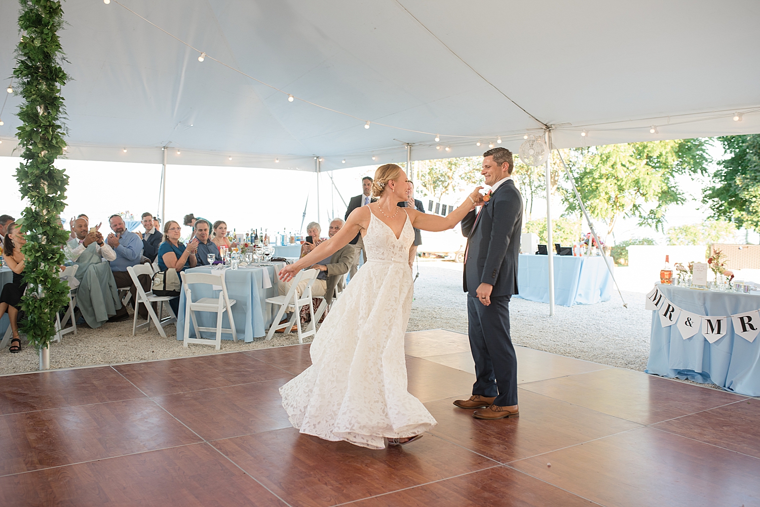 bride and groom first dance under tent