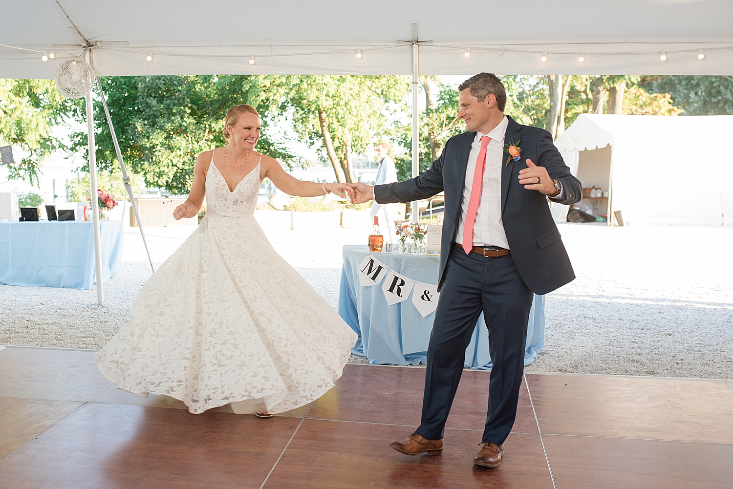 bride and groom first dance under tent