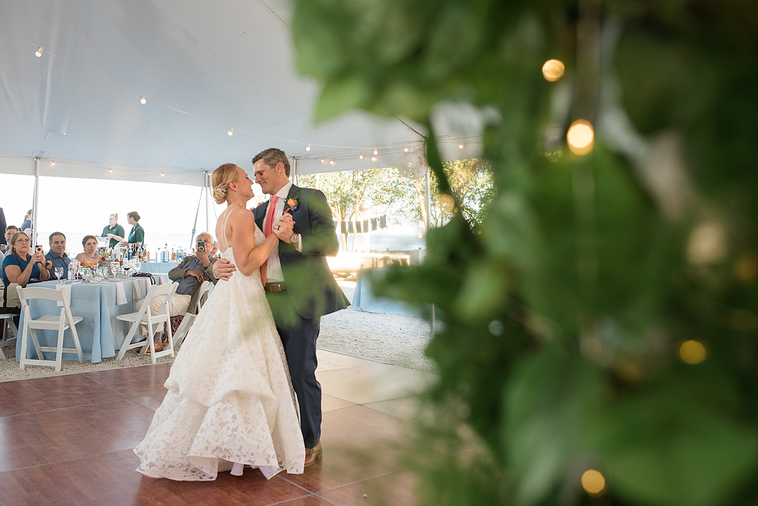 bride and groom first dance under tent