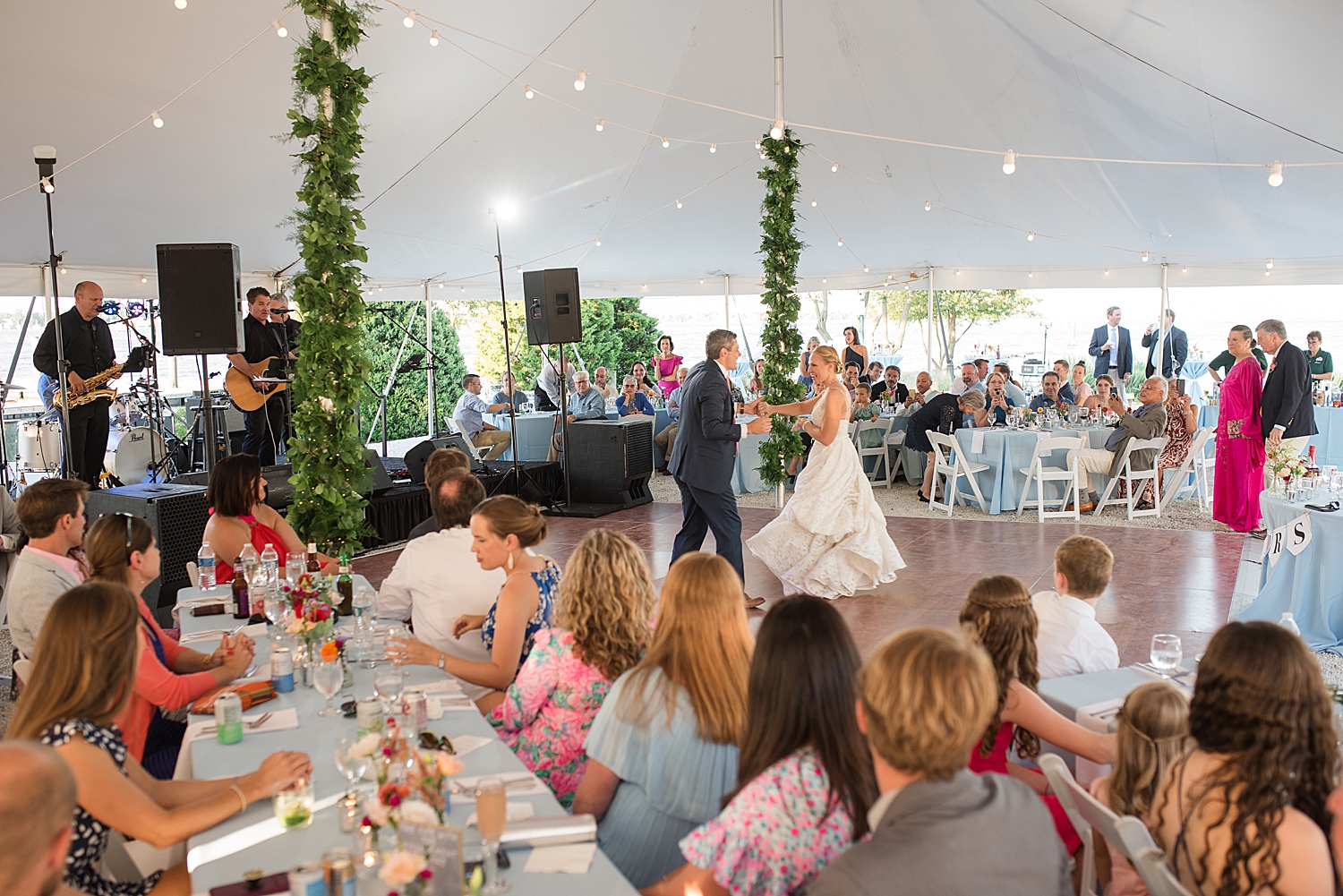 bride and groom first dance under tent wide shot