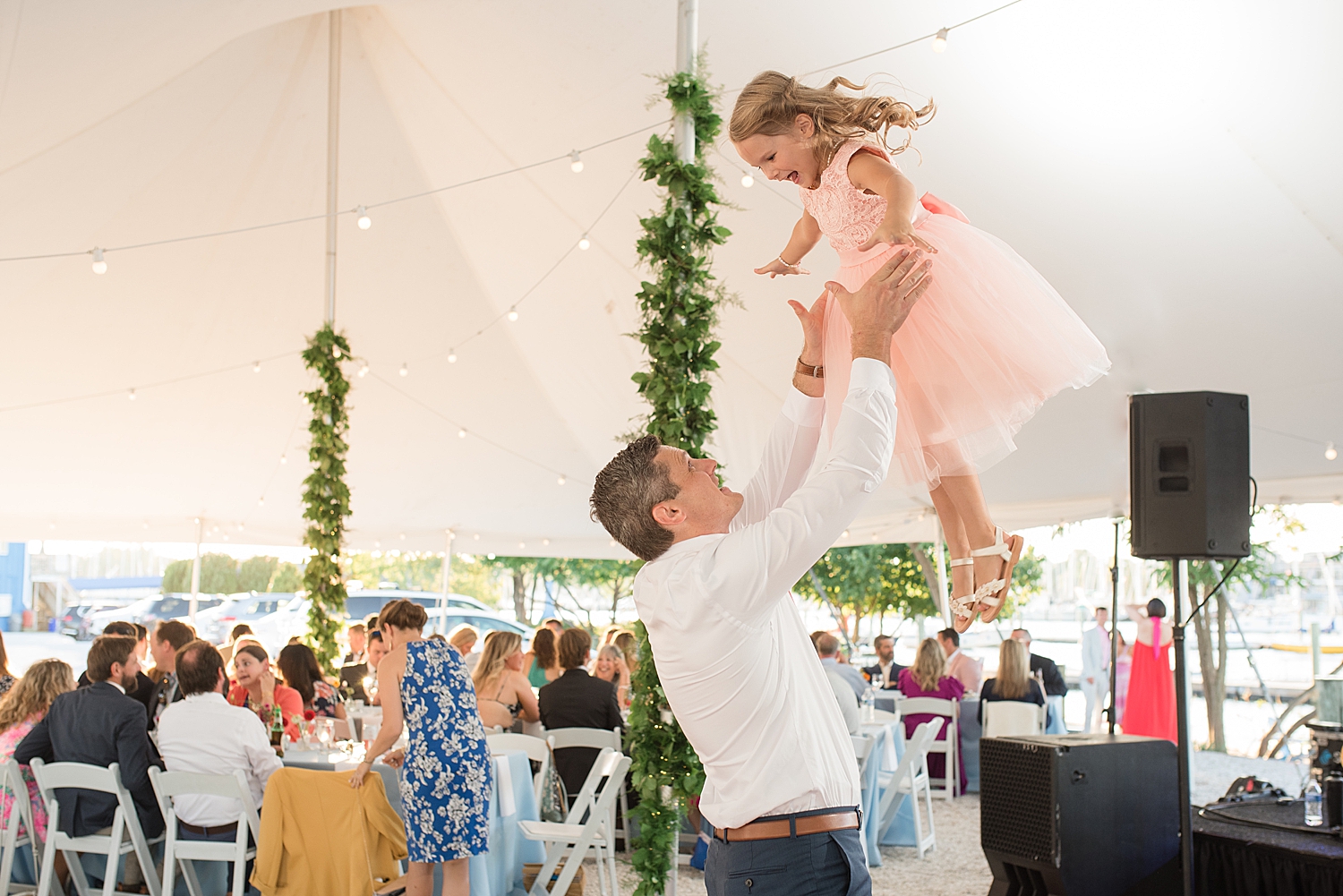 groom tosses daughter into the air