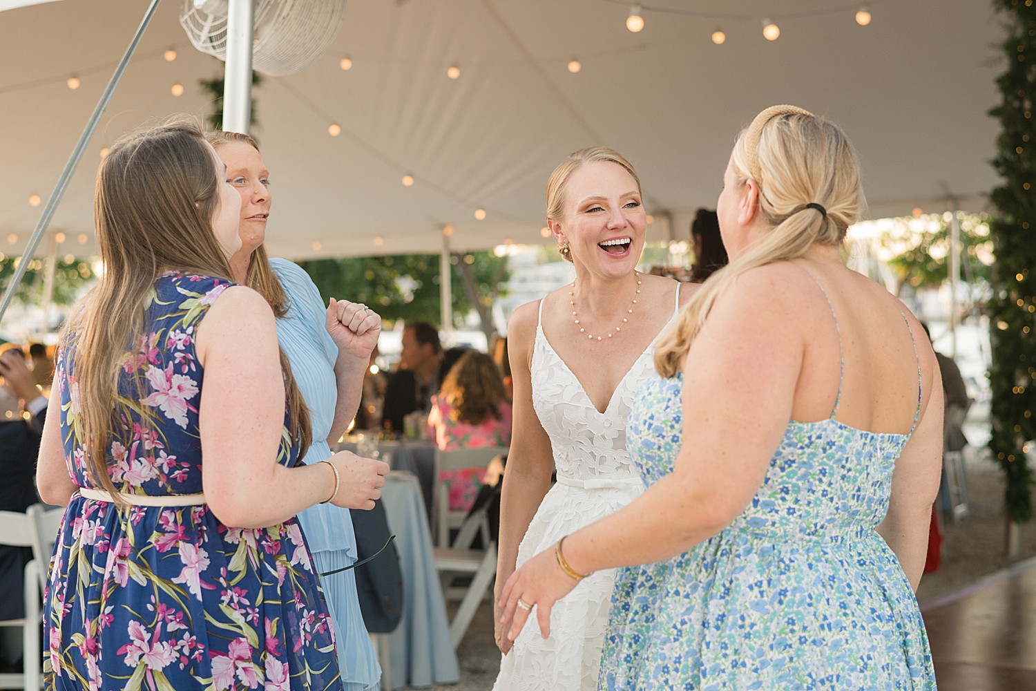 bride laughs with wedding guests