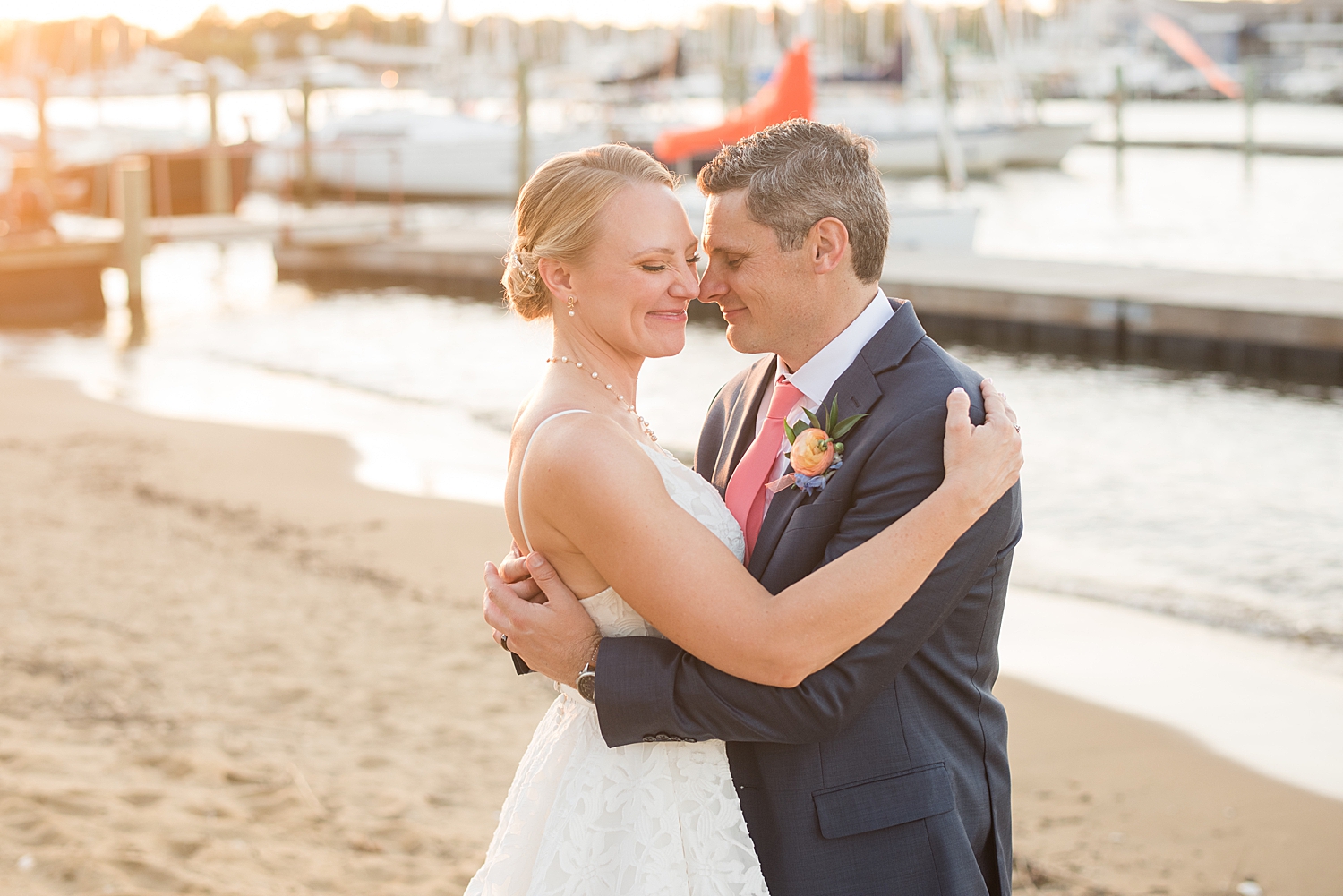 bride and groom embrace at sunset