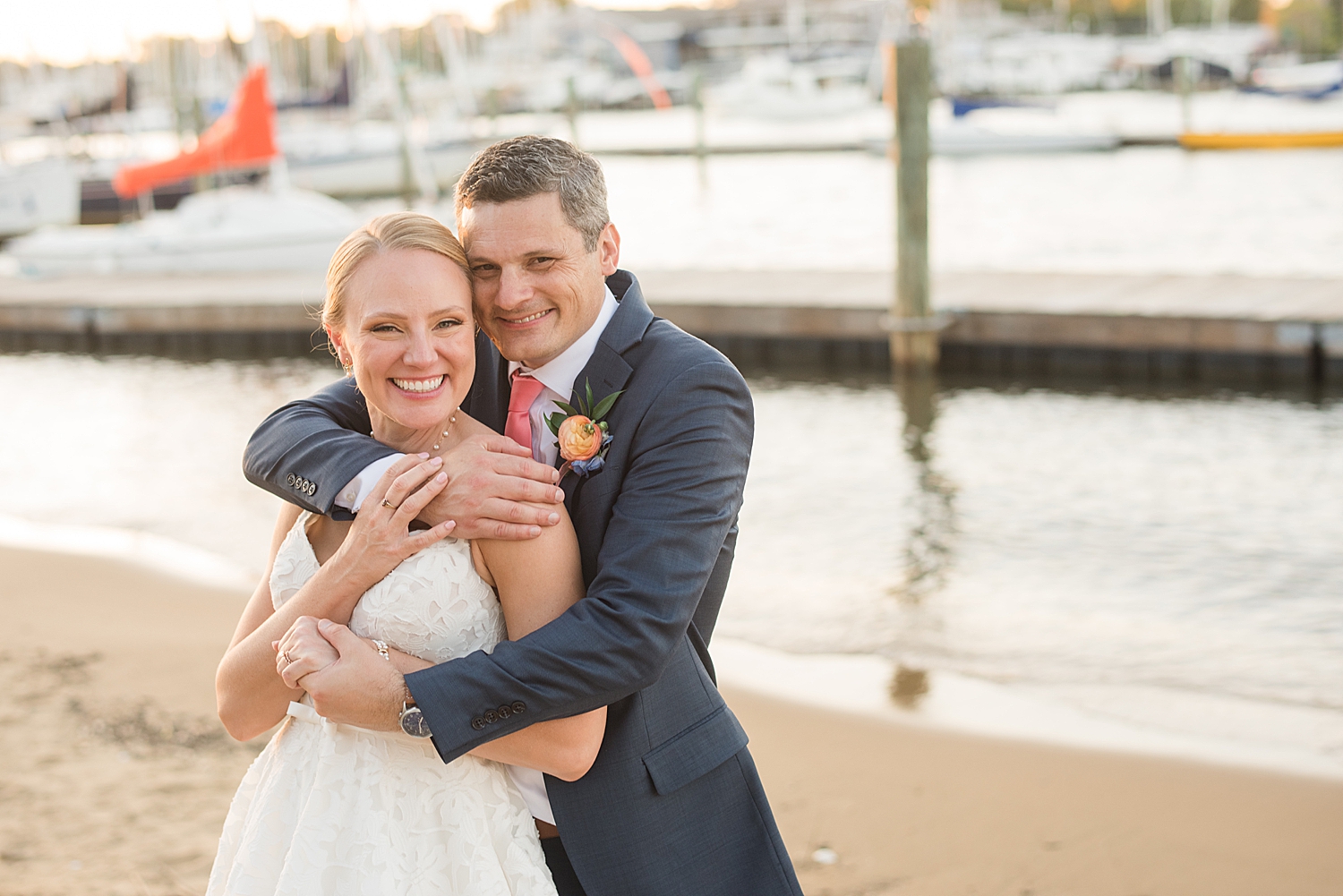 bride and groom embrace at sunset