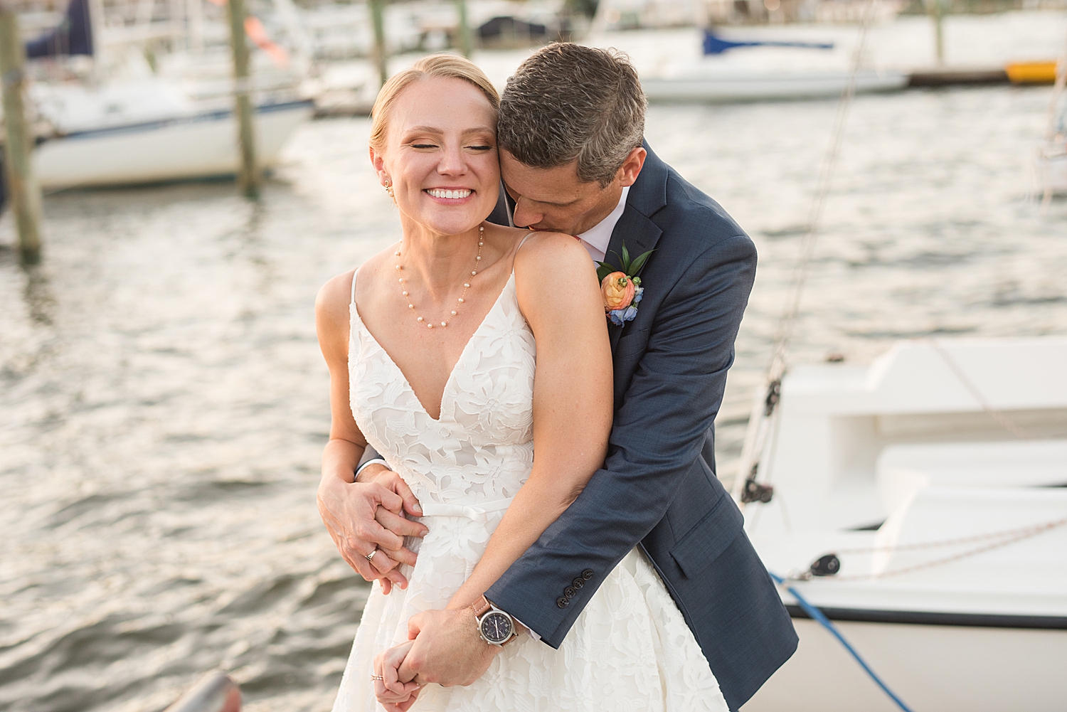 bride and groom embrace at sunset