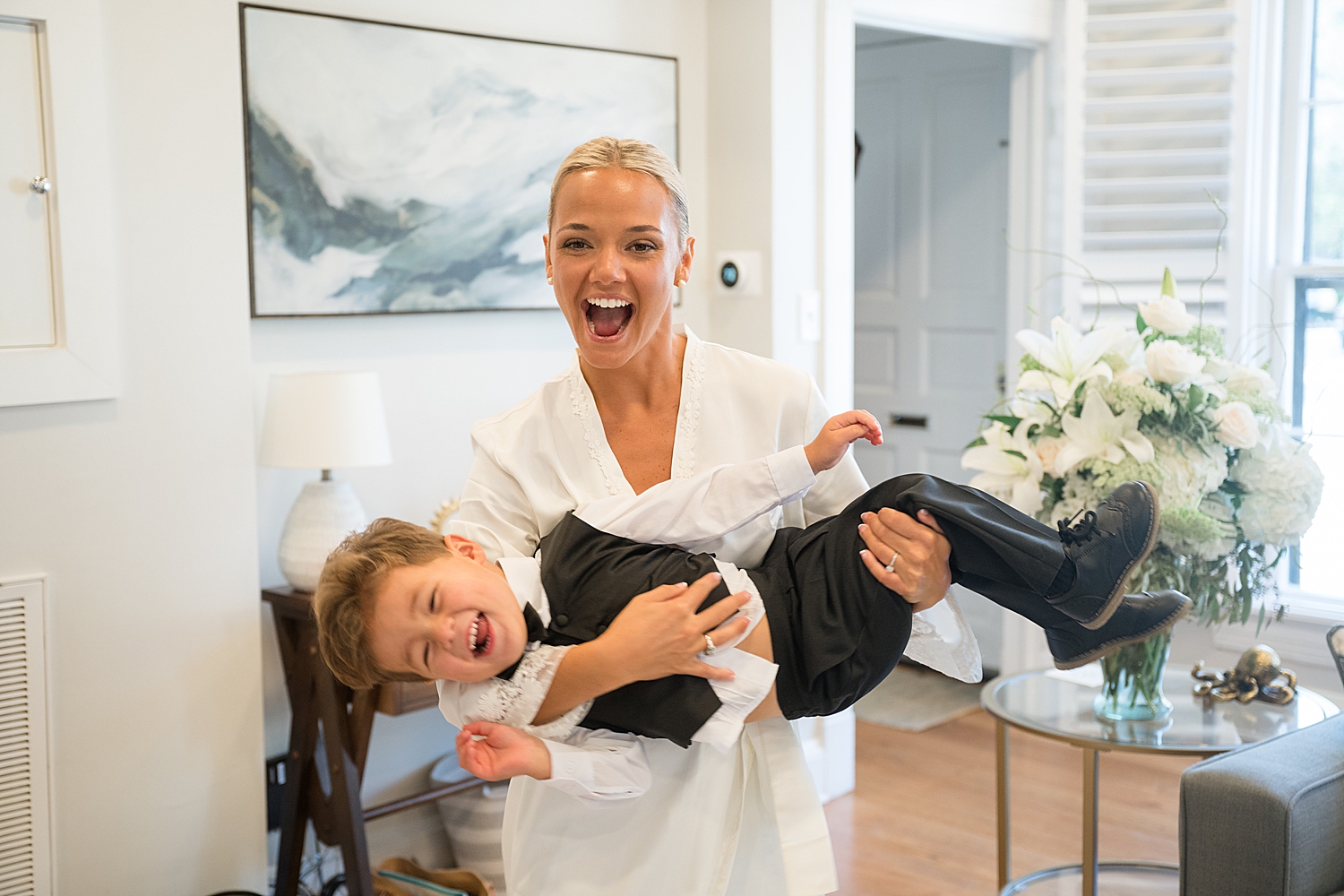 bride getting ready, playing with ring bearer