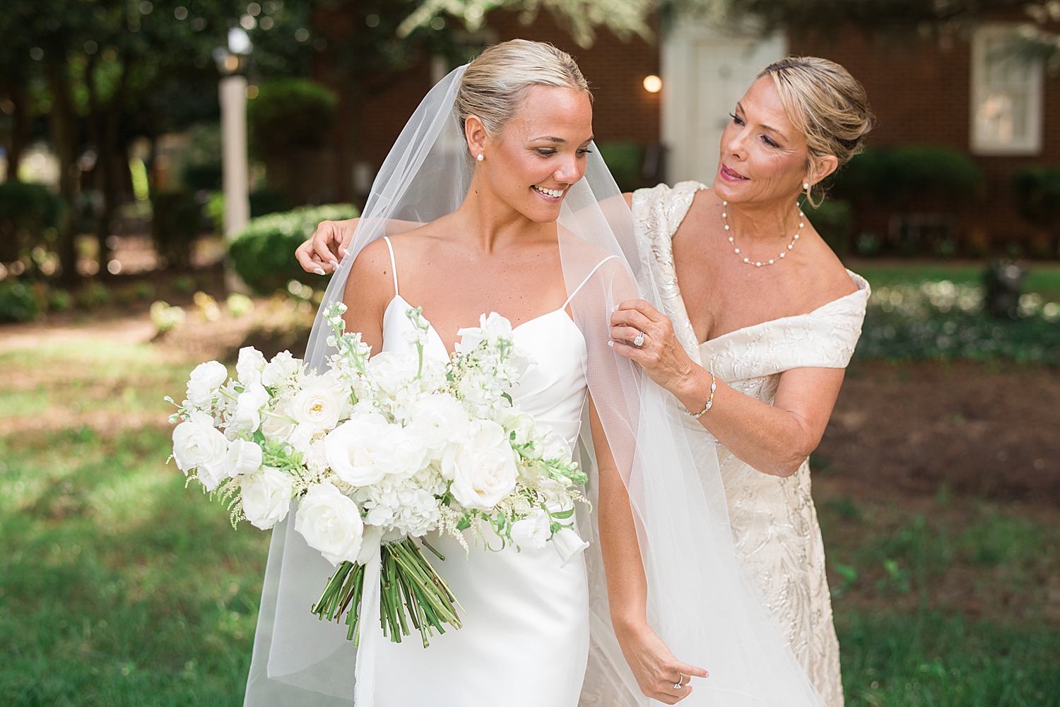 mom helps bride with veil