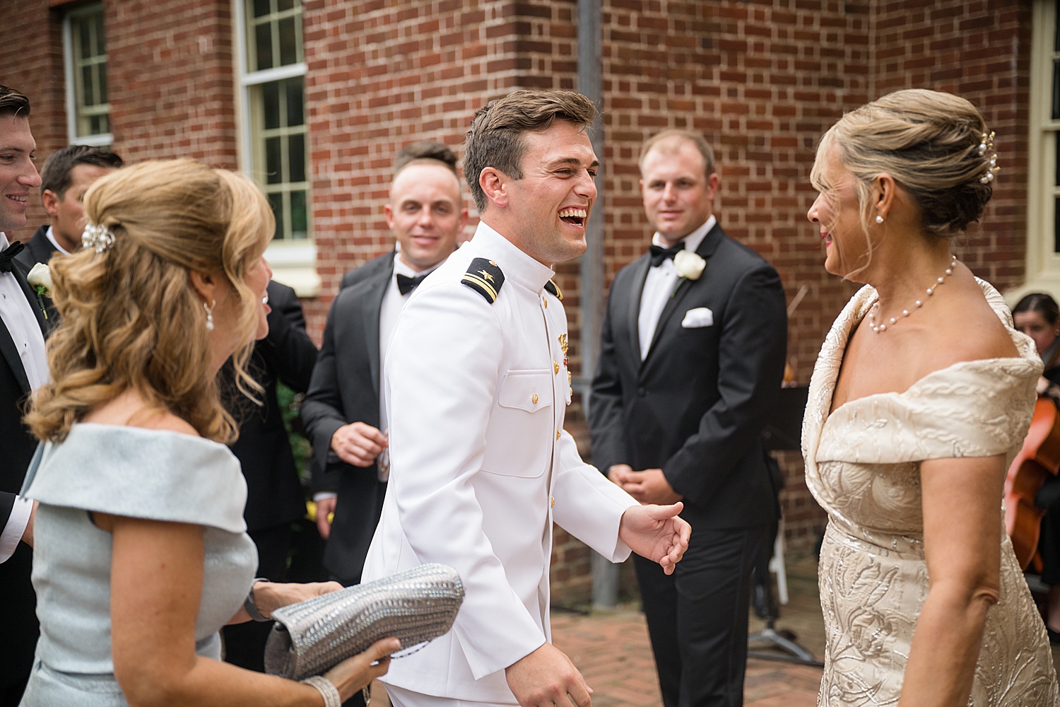 groom laughing with family