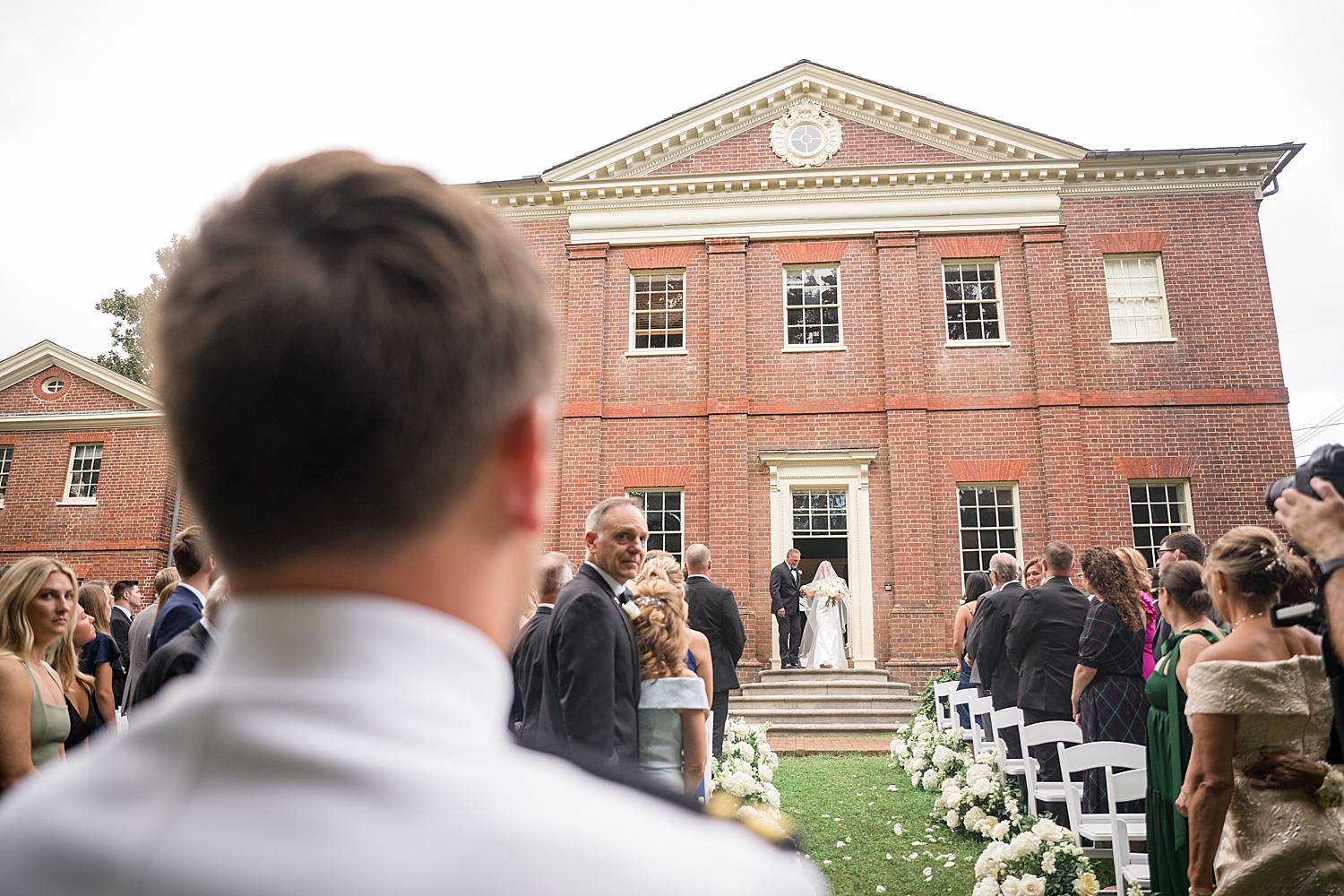 groom sees bride coming out for ceremony