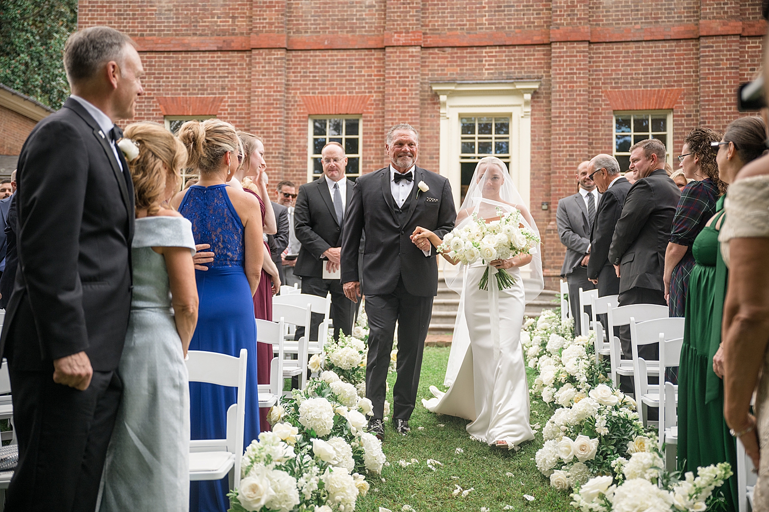 bride walks down ceremony aisle