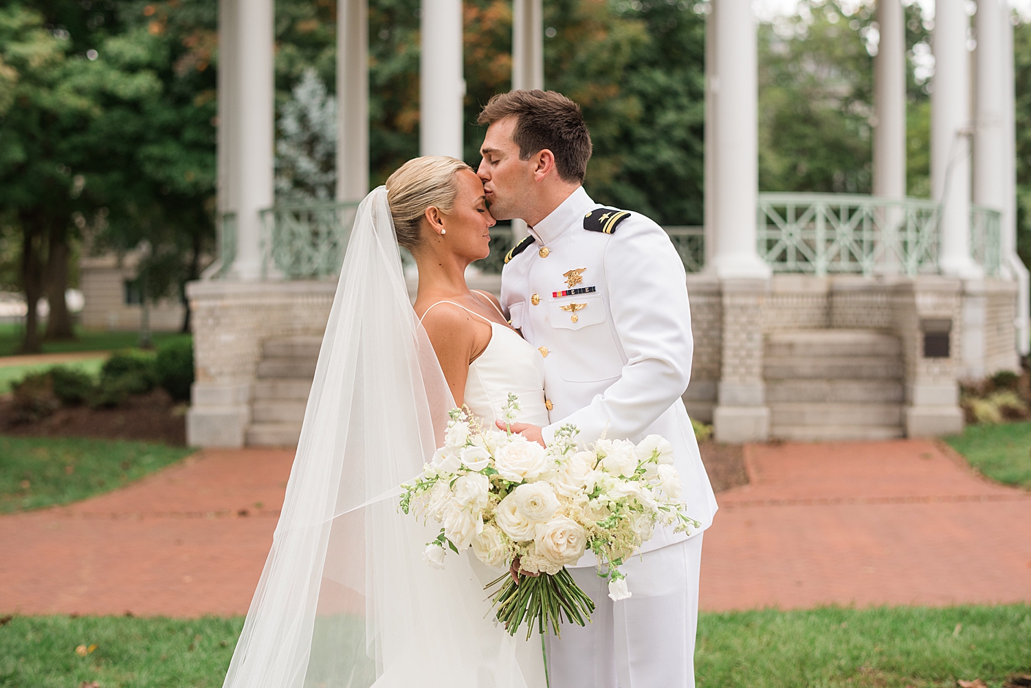 groom kisses bride's forehead