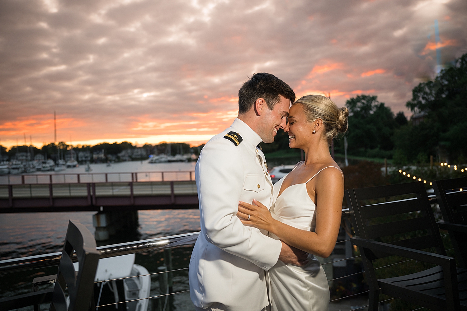 bride and groom embrace at sunset