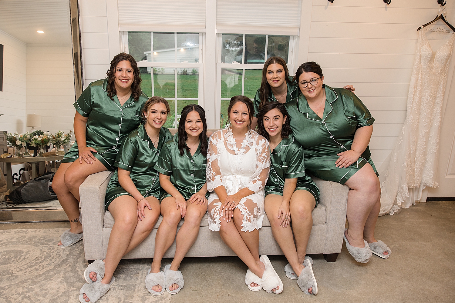 bride getting ready with bridesmaids in emerald robes