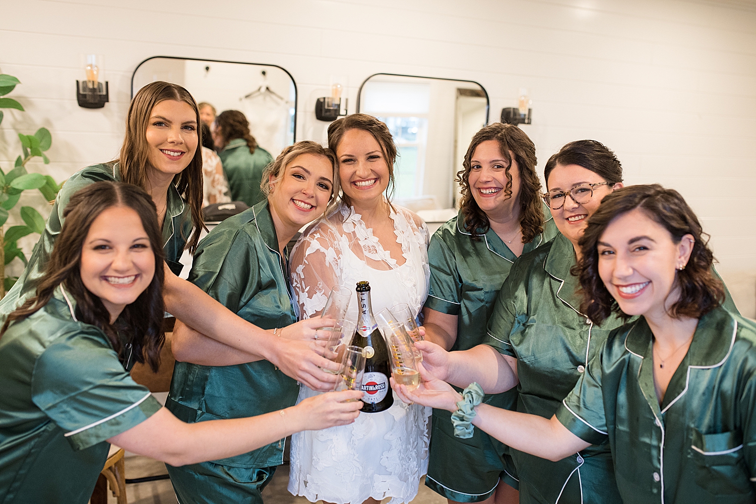 bride getting ready with bridesmaids in emerald robes