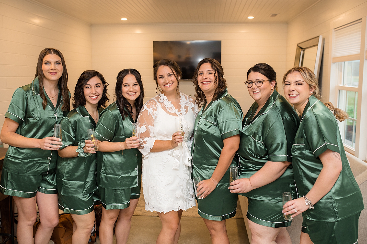 bride getting ready with bridesmaids in emerald robes