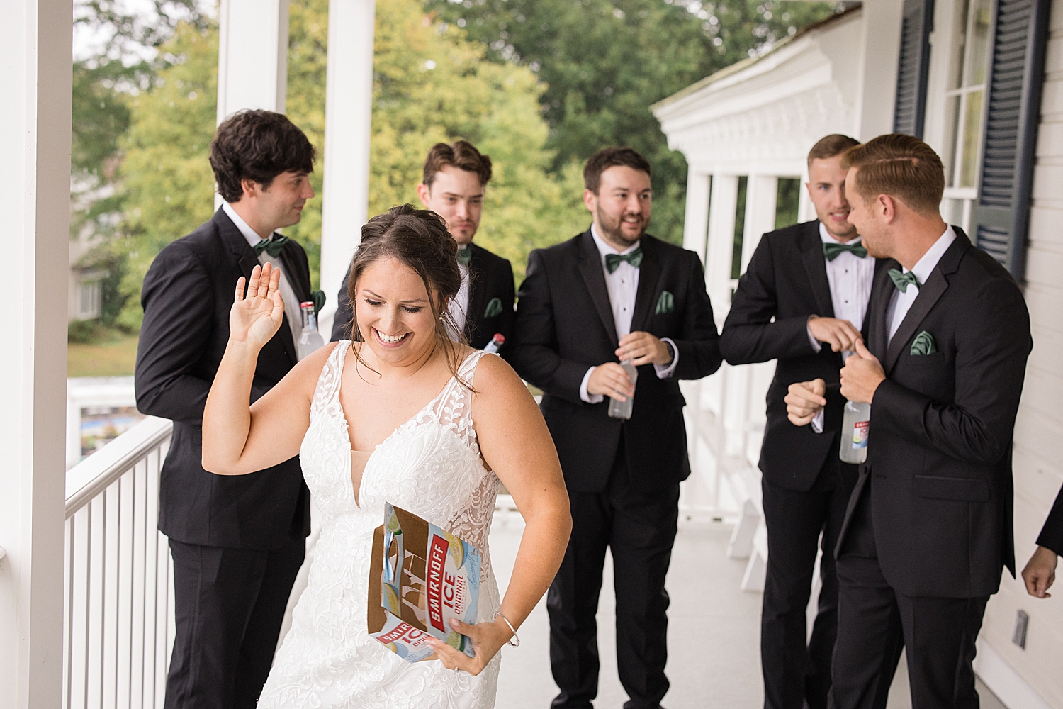 bride laughs after icing groomsmen