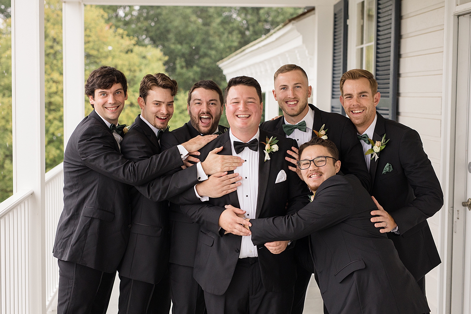 groom and groomsmen portrait on porch at kent island resort