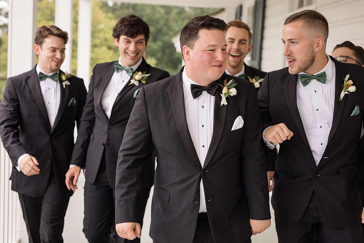 groom and groomsmen portrait on porch at kent island resort