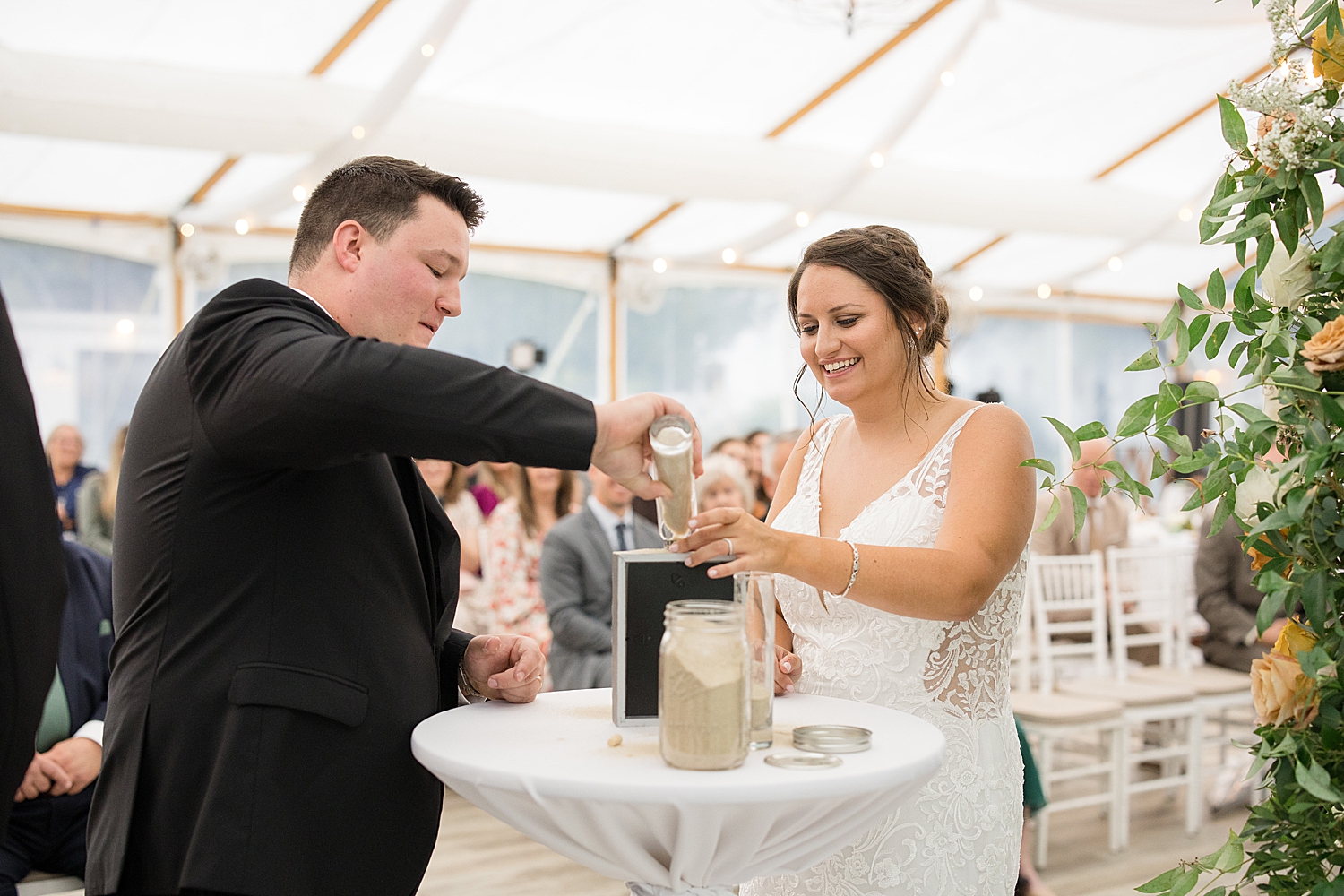 bride and groom pour sand during ceremony