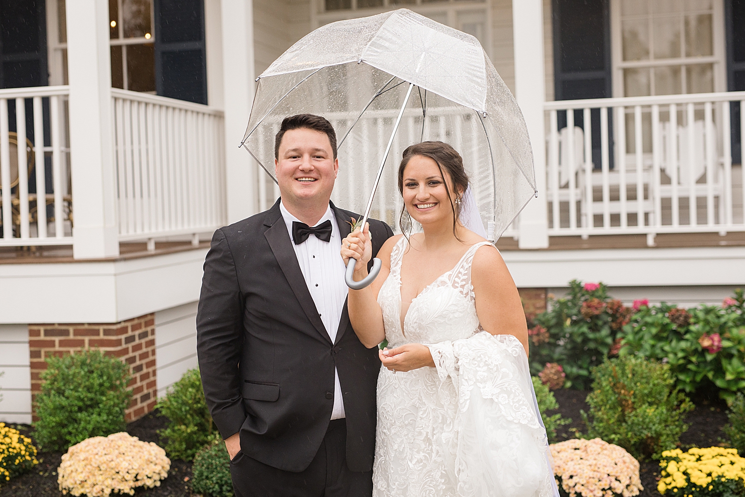 couple portrait holding umbrella in the rain