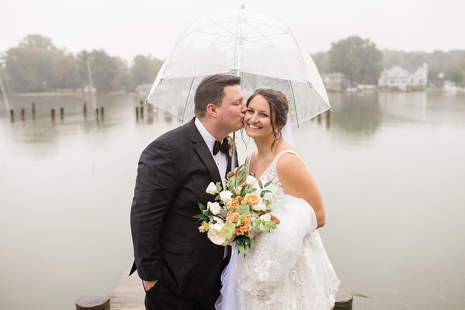 couple portrait holding umbrella in the rain